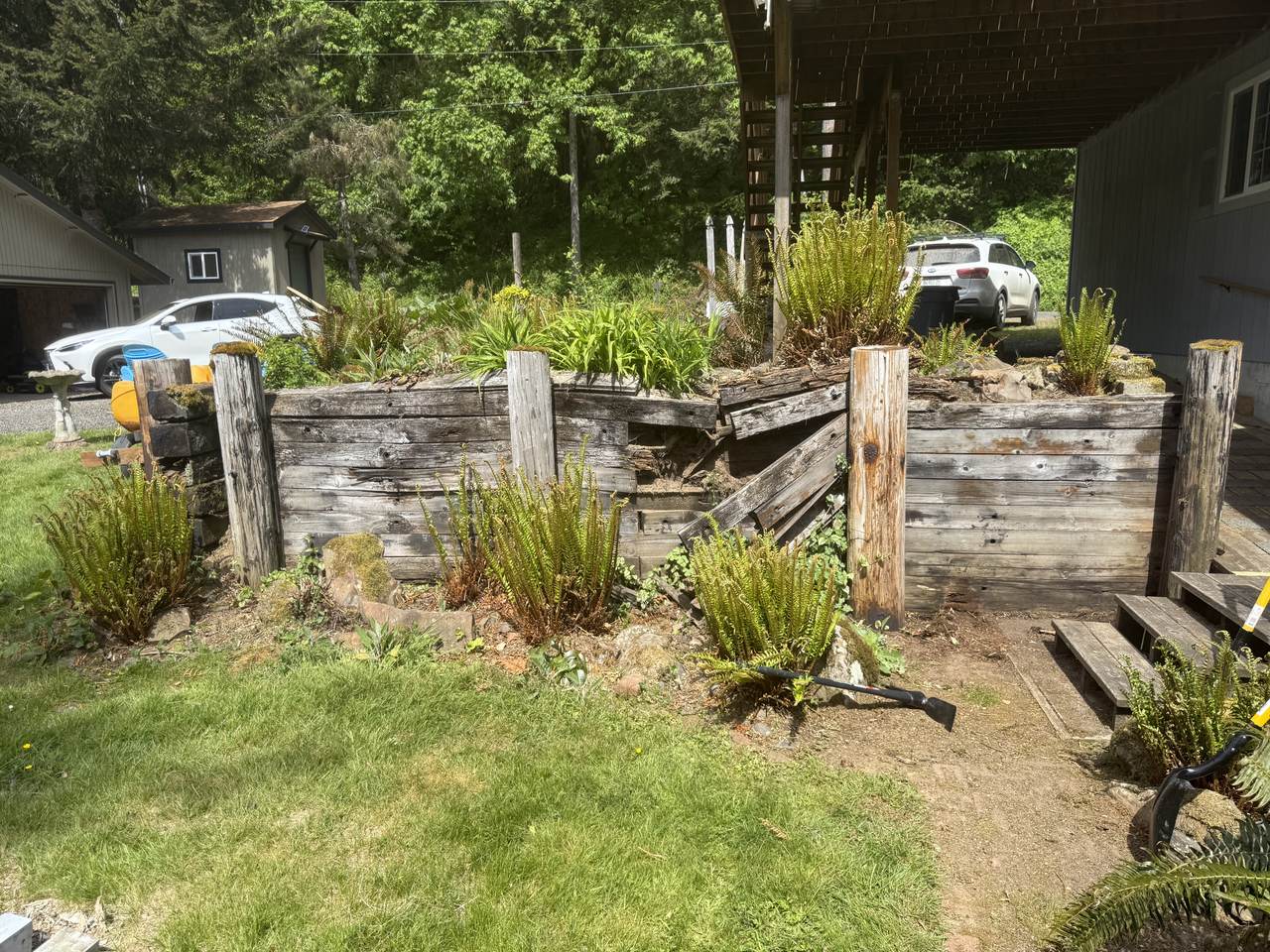 Old timber retaining wall pulling apart and spilling soil