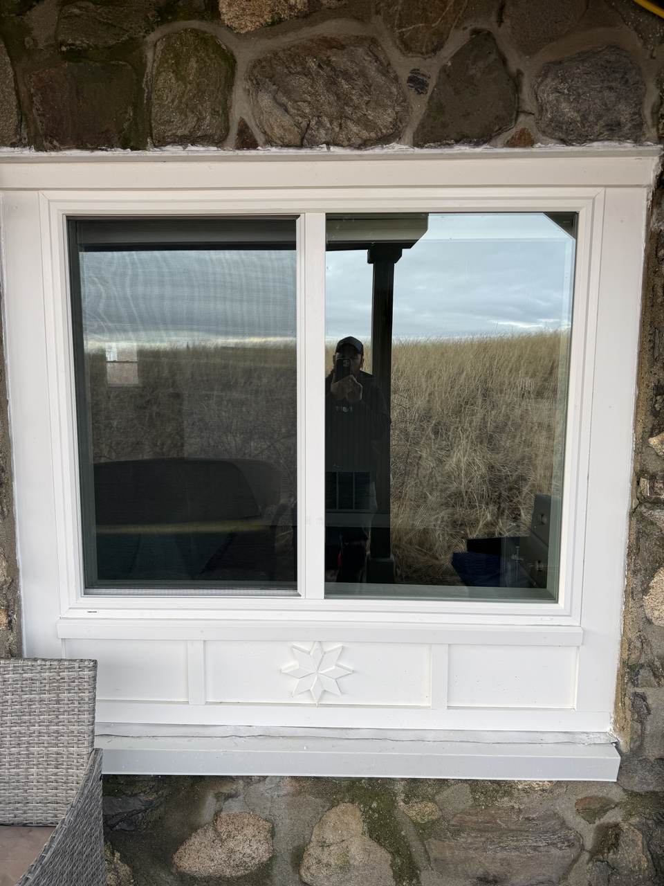 The same opening with a new window, new casing, apron panel and a carved star medallion
